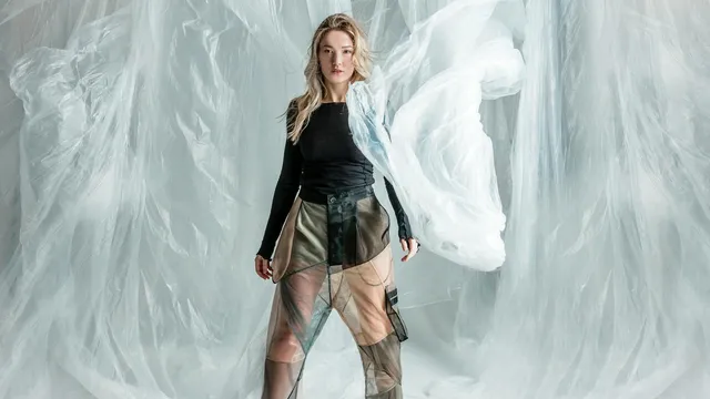 Fashion brand transparency, model showcasing garment with layered materials