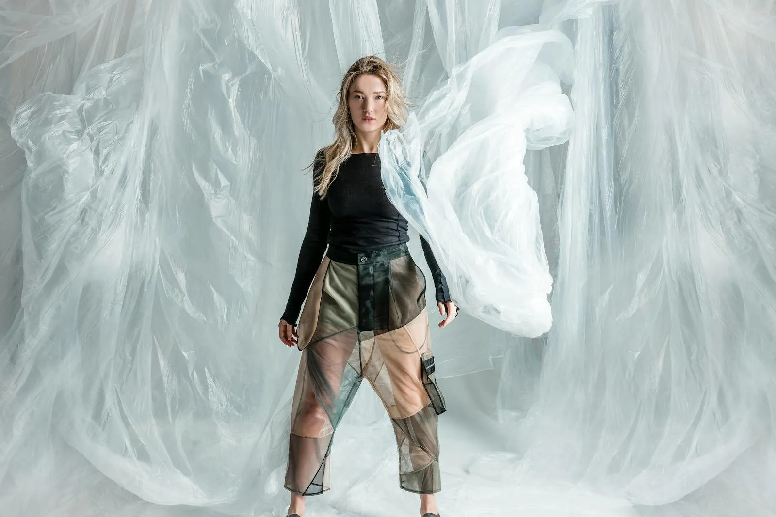 Fashion brand transparency, model showcasing garment with layered materials