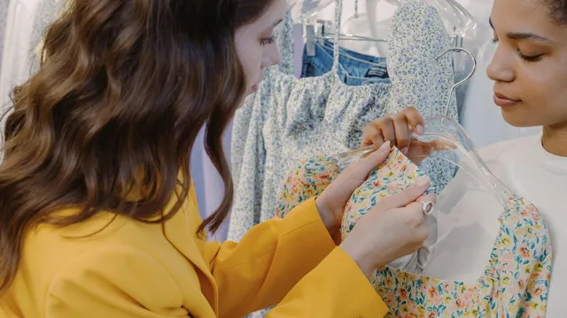Two women shopping for dresses in a boutique, anti-greenwashing regulation requires verifiable sustainability claims