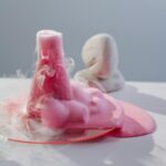 Vibrant pink foam overflowing from a flask in a clean, modern laboratory setting.