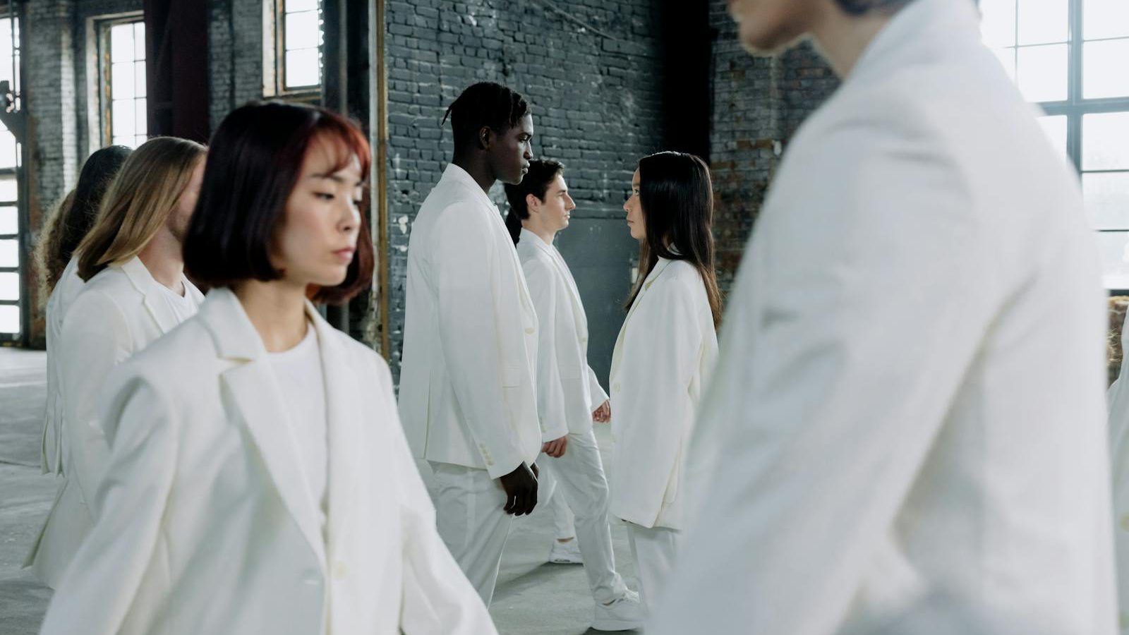 EU digital product passport regulation — diverse models in white suits walking indoors with natural light