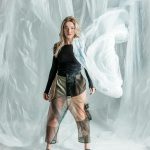 Fashion brand transparency — model showcasing garment with layered materials