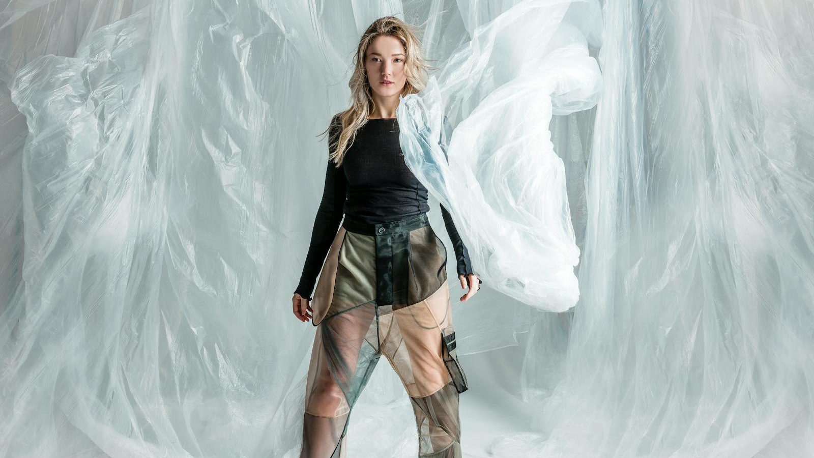 Fashion brand transparency — model showcasing garment with layered materials