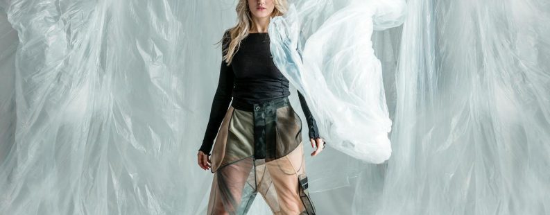 Fashion brand transparency — model showcasing garment with layered materials