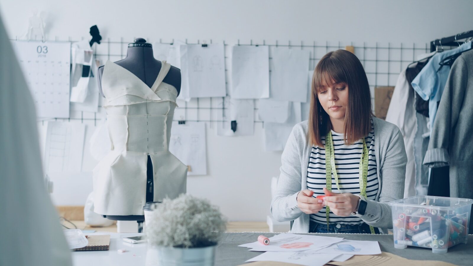 Small fashion brand designer preparing a Digital Product Passport in her studio